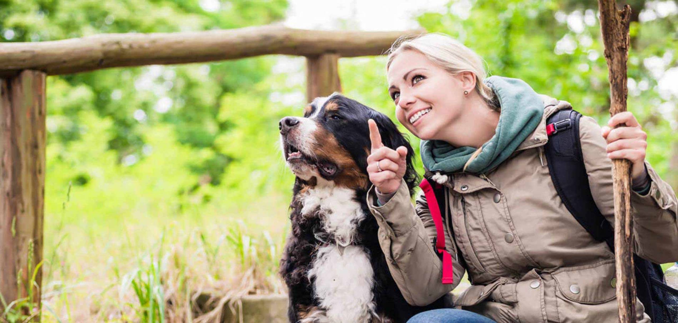 Hiking Woman With Rucksack and Dog - Cabin Rental